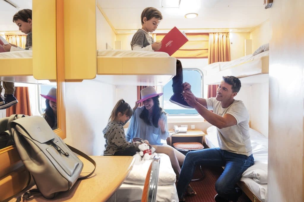 Mom, dad, young son and daughter in a ferry cabin in a Superfast Ferries vessel.